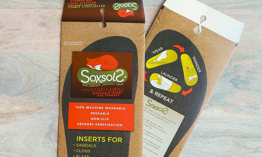 Retail display packaging for SoxsolS, featuring a unique hanger hole and windowed packaging for the sole inserts.
