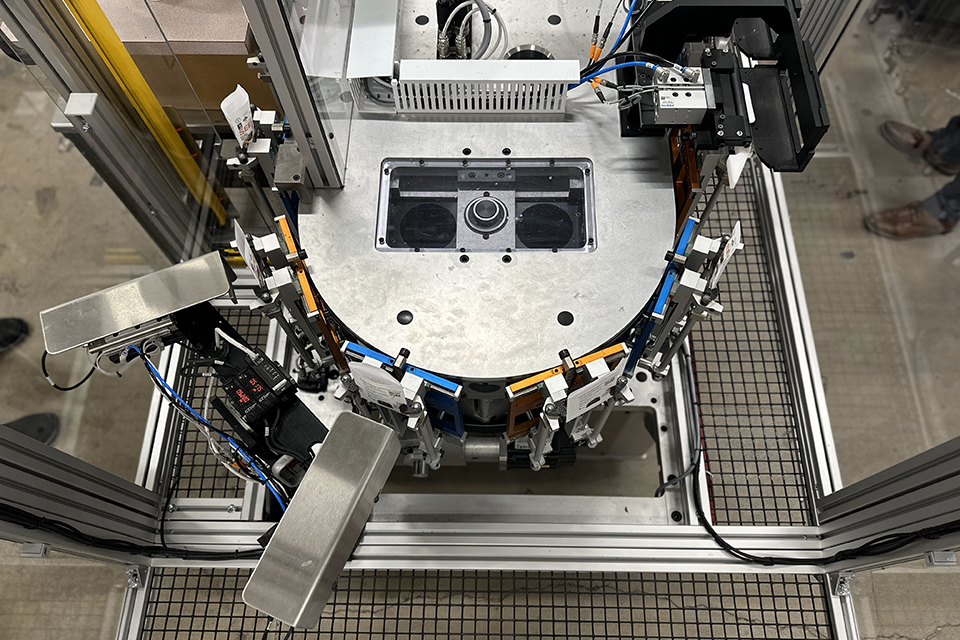 An automated industrial packaging machine used at JBM Packaging, a sustainable paper packaging company.