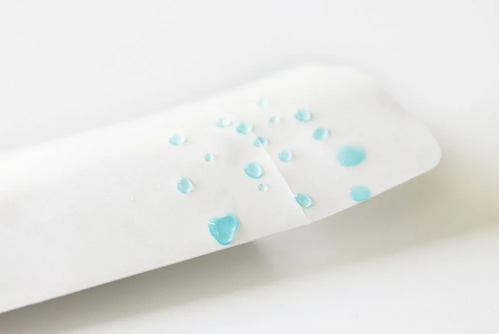 White water-resistant Hydroblox envelope with beaded water droplets.
